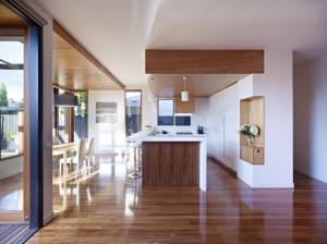 Parquet-wooden-floor-laminated-white-wall-white-ceiling-white-pendant-lamp-white-kitchen-cabinet-wooden-furniture-615x461