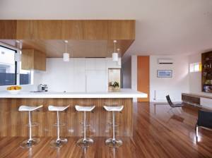 White-bar-stool-white-pendant-lamp-parwuet-teak-wood-floor-aminated-wooden-door-white-kitchen-cabinet-ac-615x461
